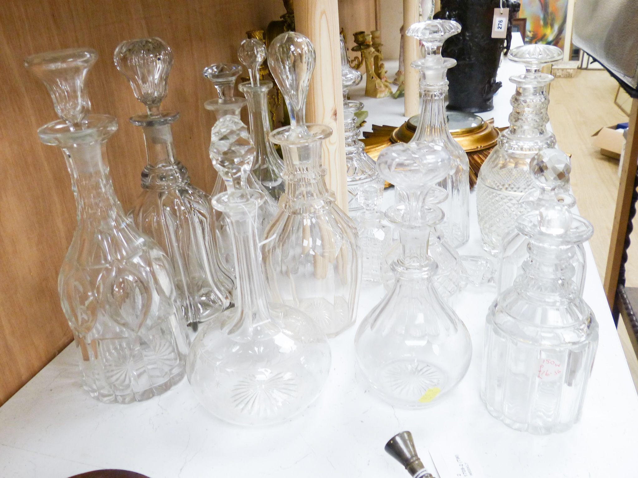 A collection of thirteen cut glass decanters